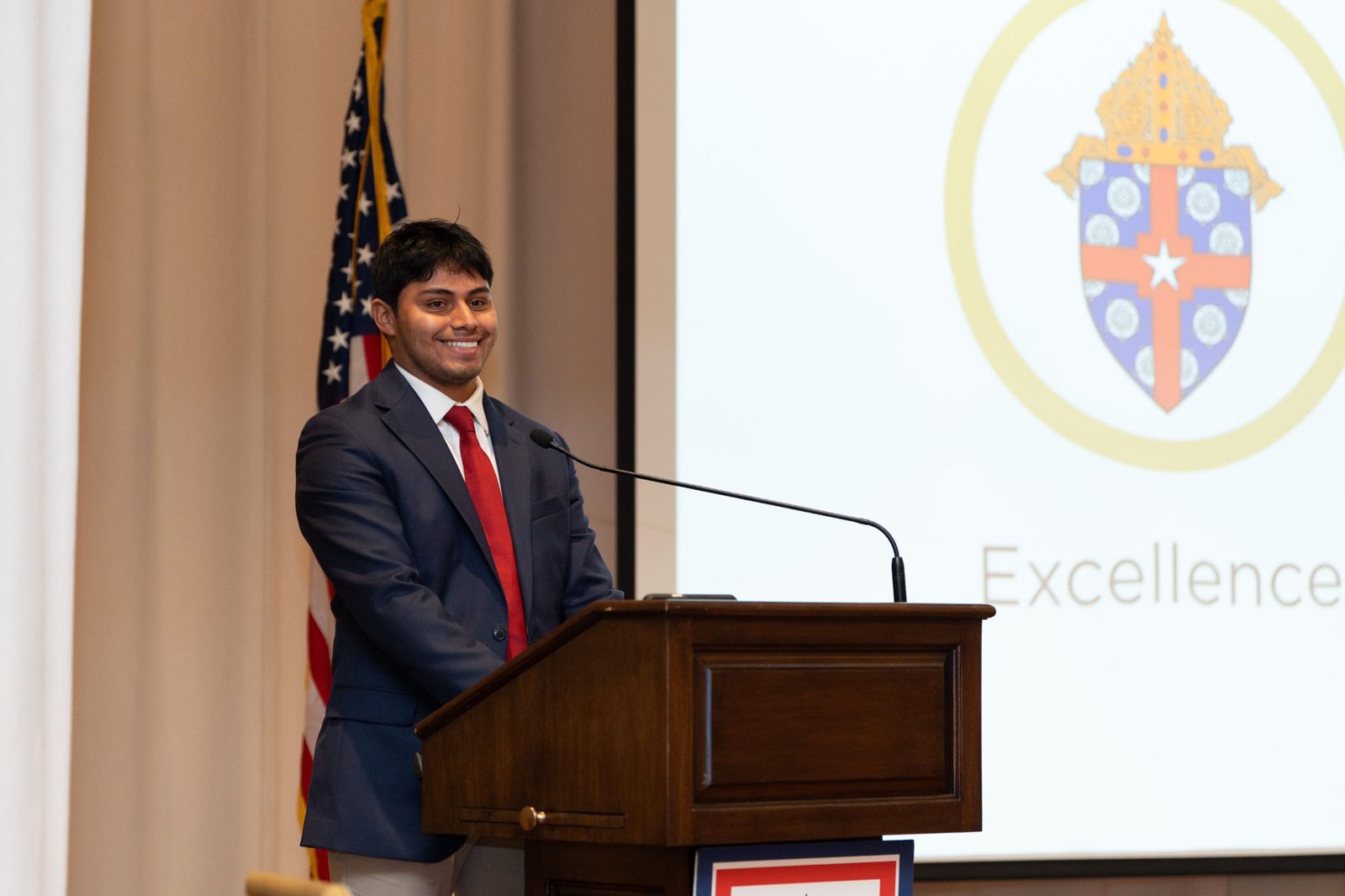 Manny Campos speaking at a podium at an Archdiocese of Galveston-Houston event