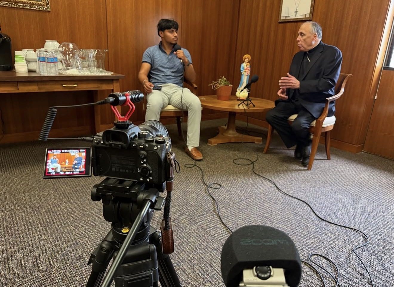Manny Campos interviewing a cardinal for The Manny Perspective podcast